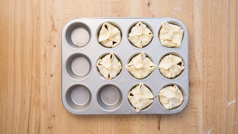 unbaked croissants in muffin tin