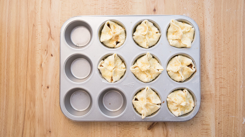 unbaked croissants in muffin tin