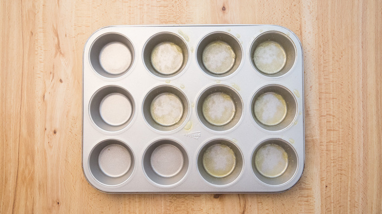 greased muffin tin on table
