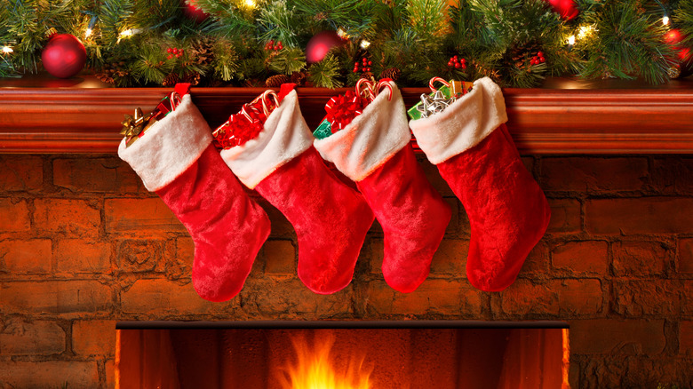 Christmas stockings hanging on mantle above fireplace