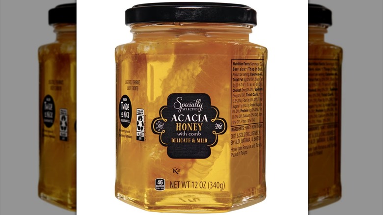 Jar of honey with honeycomb