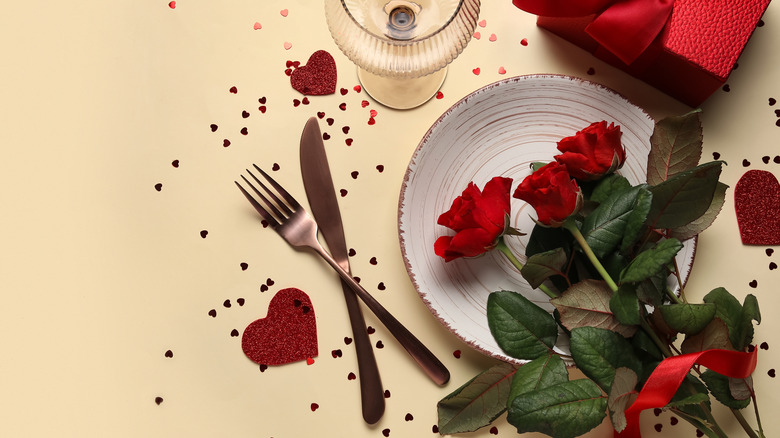 Romantic Valentine's Day table setting with red roses