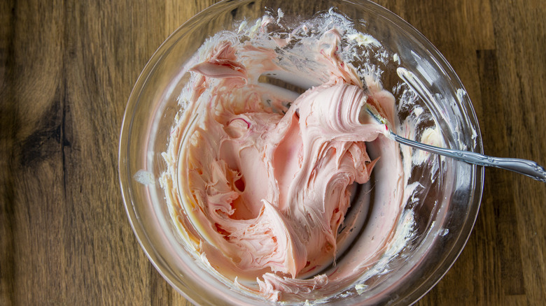 pink frosting in a bowl