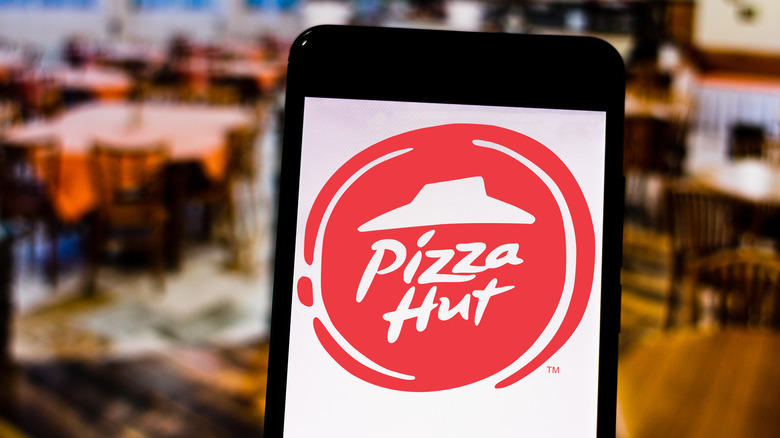 The Pizza Hut logo on a cell phone.