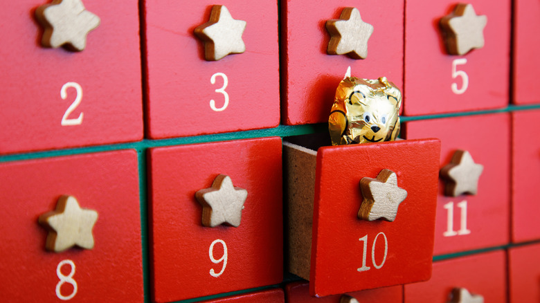 Red advent calendar with chocolate sticking out