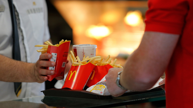 McDonald's employee placing food on tray