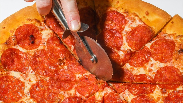 cutting pizza with slicer