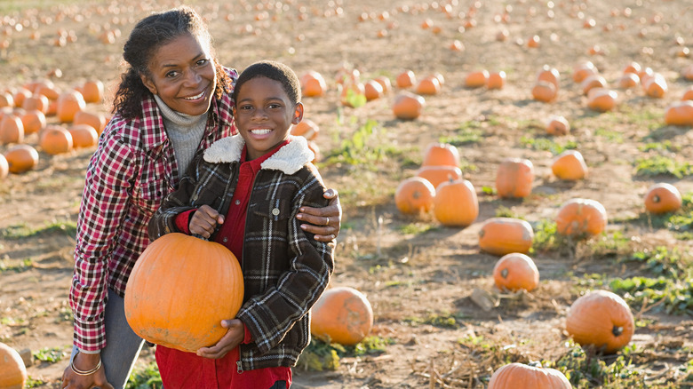 mom and boy with pumpkin