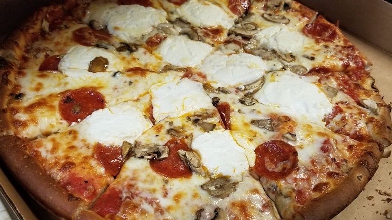 a fresh pizza with mozzarella and pepperoni