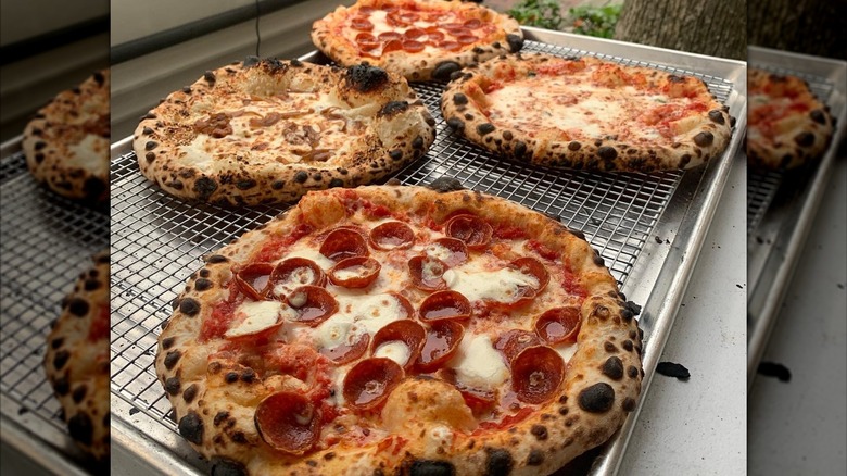 several fresh cheese and pepperoni pizzas