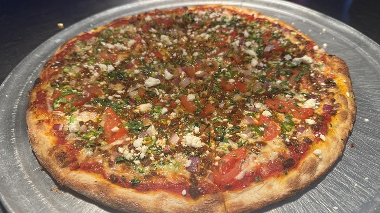 a pizza with chorizo topping