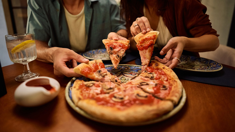 people eating pizza at a restaurant