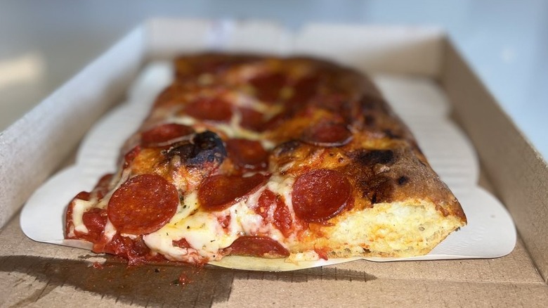 a slice of Sicilian pizza with pepperoni