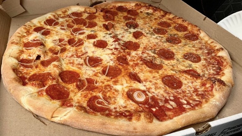 a large pizza with pepperoni and onion in takeout box from Alley Cat restaurant in New Hampshire