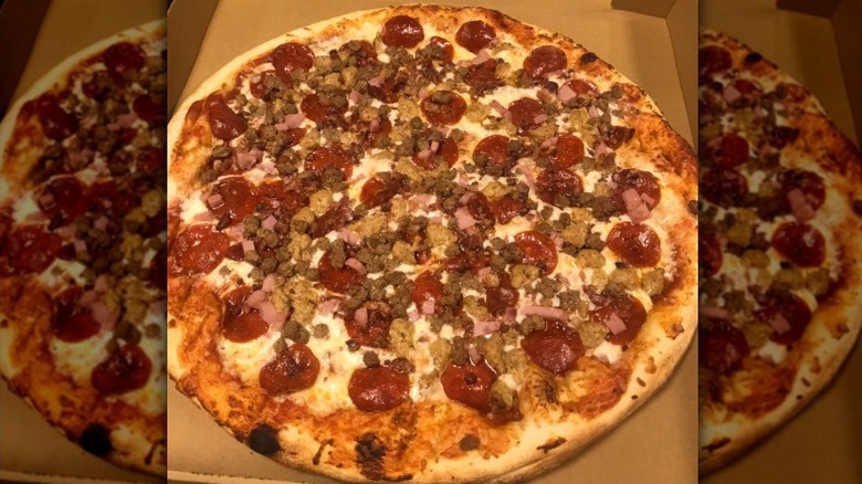 a large meat and pepperoni pizza in takeout box from Ari's Pizza in North Carolina