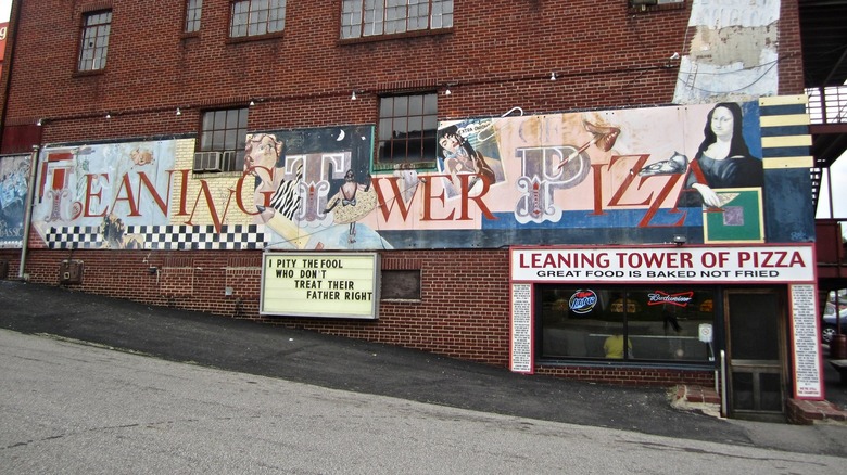 exterior of Leaning Tower of Pizza restaurant in Mansfield, Ohio with eclectic mural on brick building