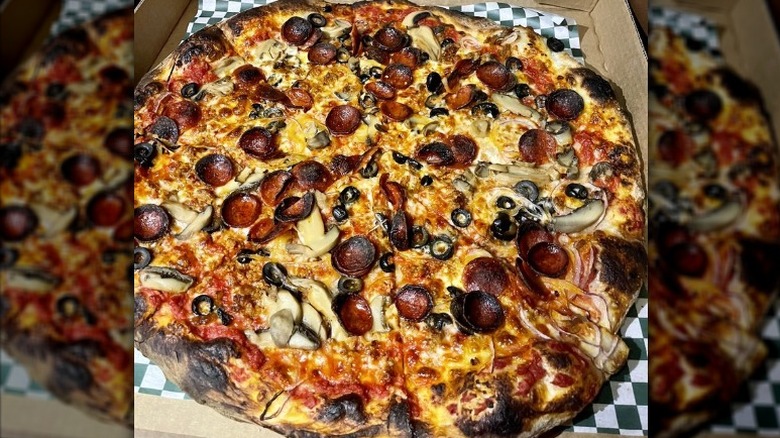 Pizza with pepperoni, sausage, onions, olives and mushrooms in takeout box from Pizza Marvin in Rhode Island