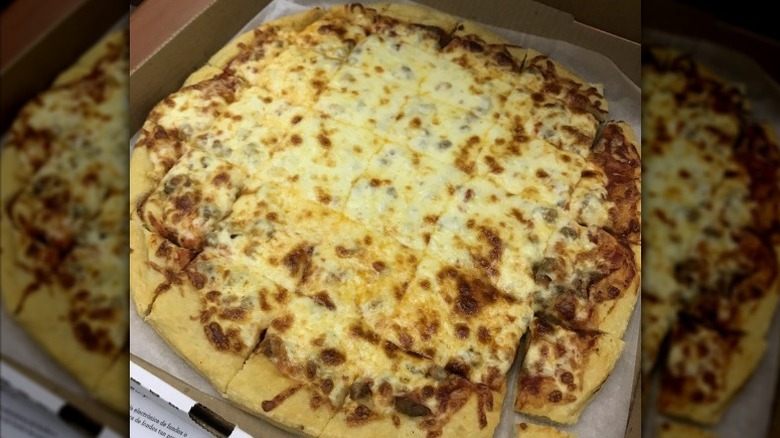 large beef pizza with lots of cheese cut into squares in takeout box from Empire Pizza restaurant in South Dakota