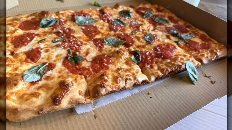 Little Italy Midtown restaurant's grandma's pizza with basil in takeout box