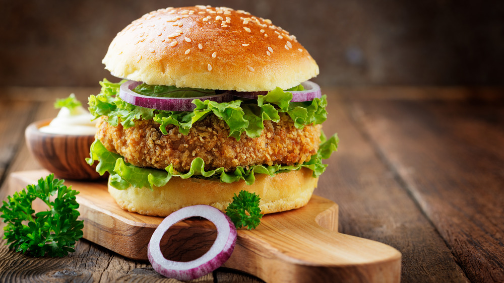 Fried chicken sandwich on cutting board