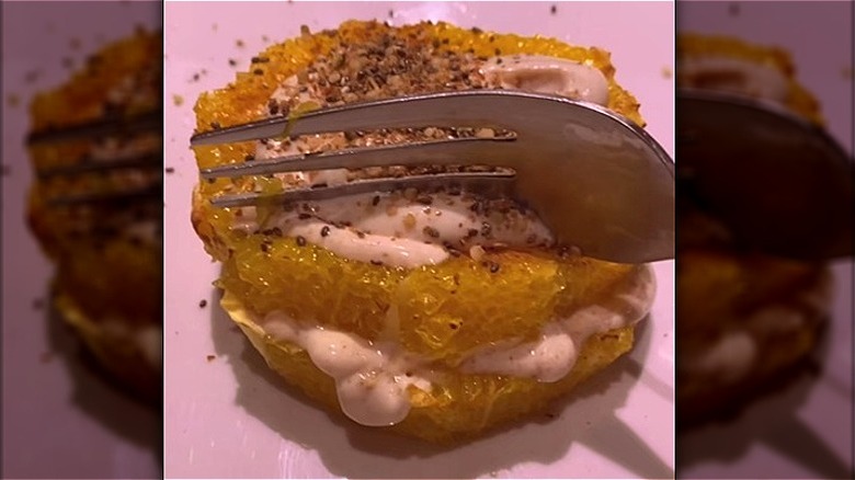 Fork cutting into air-fried orange slices