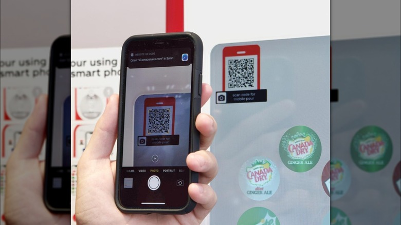 Someone using a phone app to place a Freestyle order