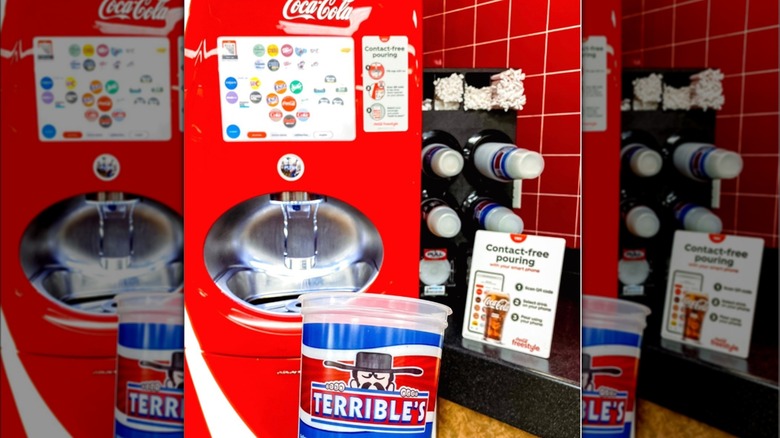 A Freestyle machine with a Terrible's Herbst cup being held up in the foreground