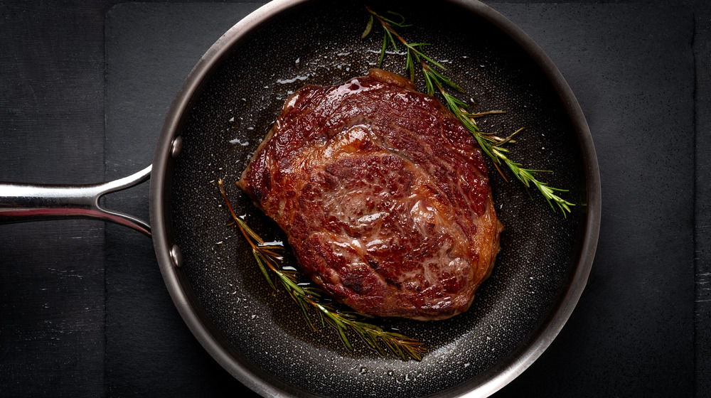 Cooked steak in frying pan