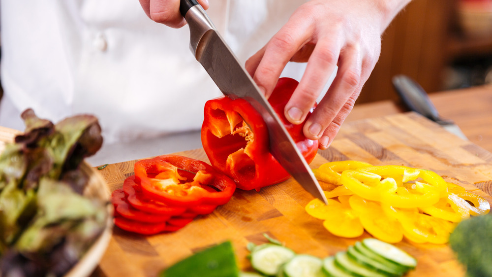 Person cutting bell pepper