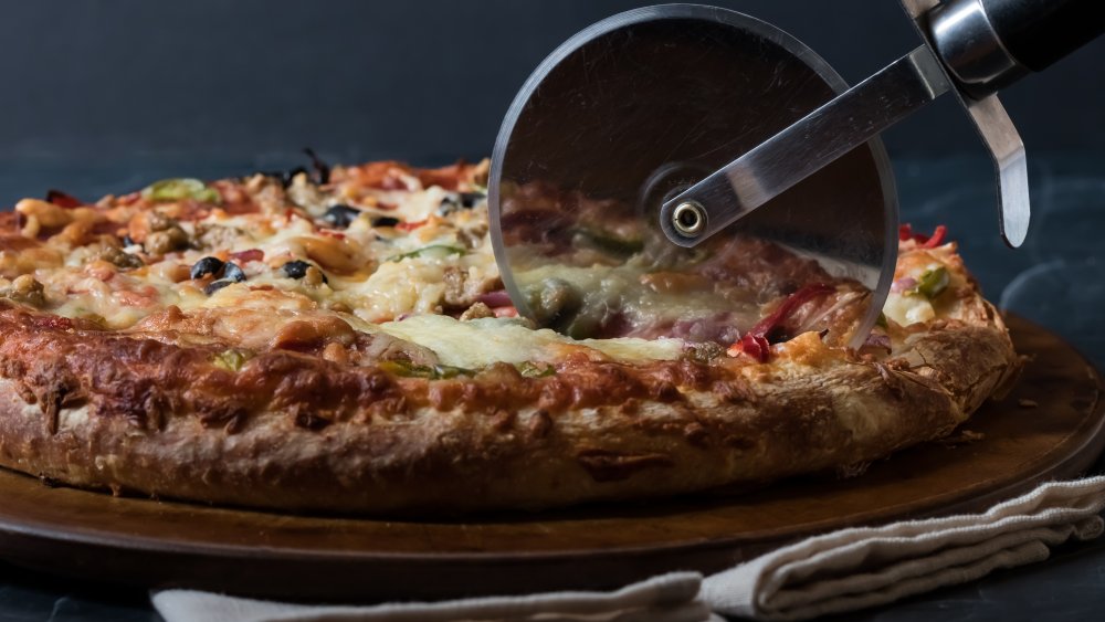 Pizza being sliced