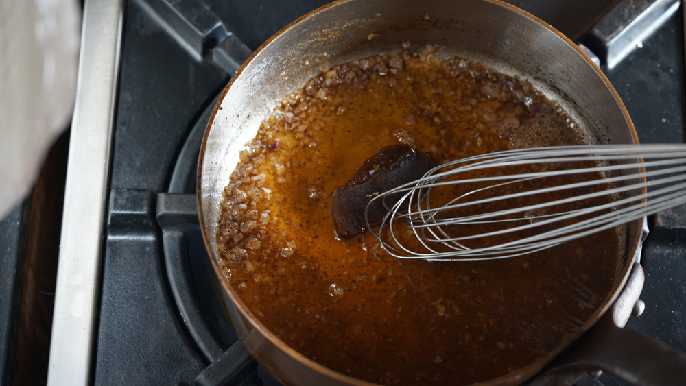 Pan being deglazed with whisk