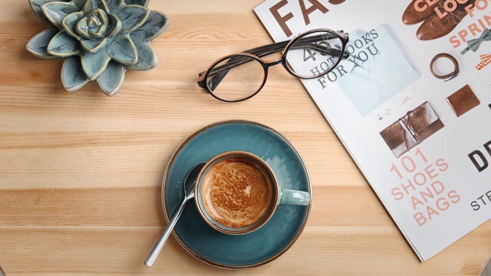 Espresso with crema, plants, office setting, modern.