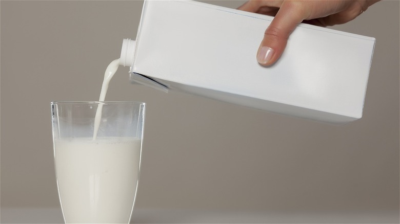 Pouring milk from carton into glass