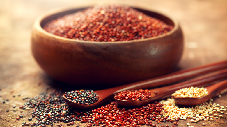 Quinoa grains in bowl and spoons