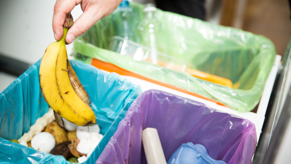 Woman throwing out banana peel