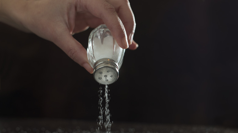 chef adding salt