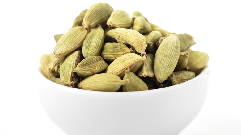 A bowl of green cardamom pods