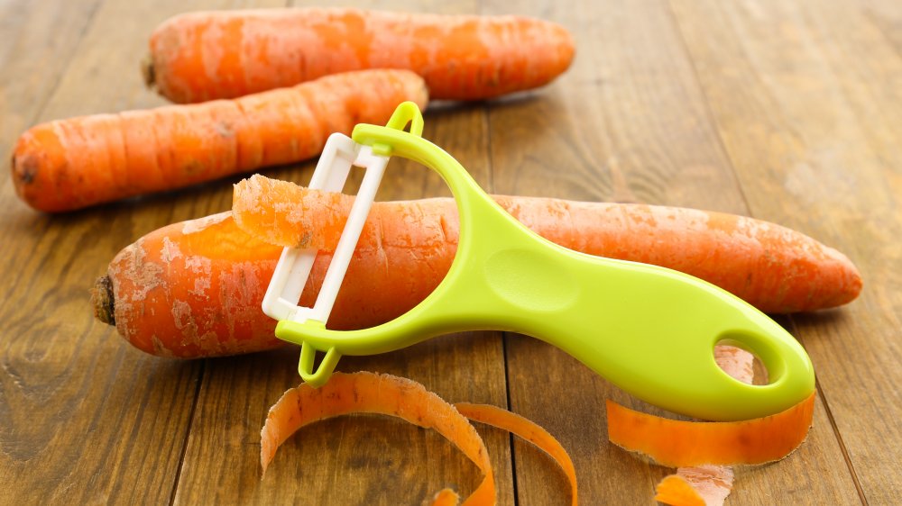 Using a vegetable peeler to remove the skin from a red