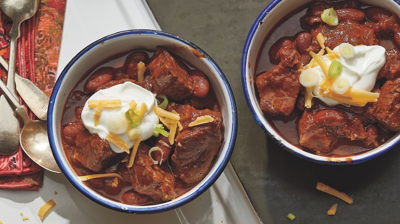 bowls of chili with toppings