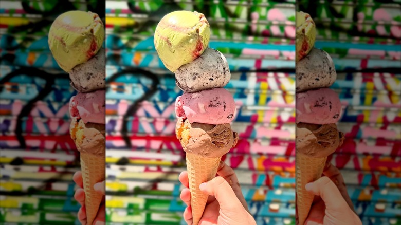 ice cream cone from OddFellows with scoops of Matcha Strawberry, Black Sesame Cookies & Cream, Raspberry Rocky Road, and Chocolate Peanut Butter Cheesecake